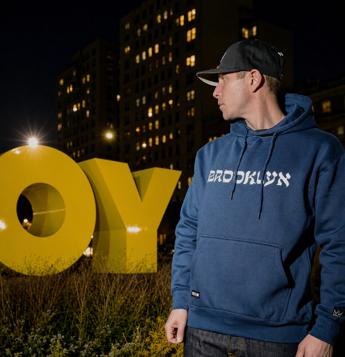 Model wearing L’Chaim Brooklyn hoodie at night