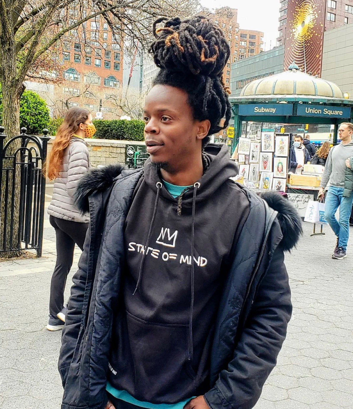 Kenny wearing a NY State of Mind hoodie at Union Square
